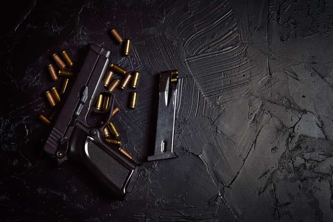 handgun shells on black painted cement